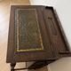 Antique wooden desk with a leather top.