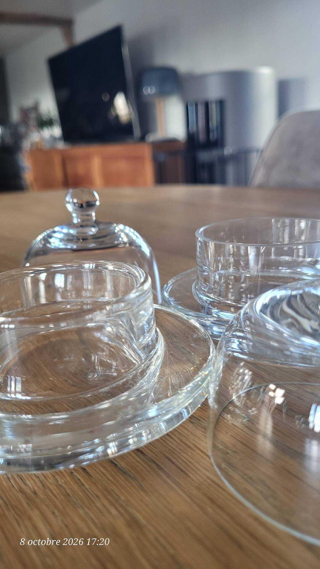 2 transparent glass butter dishes with their matching cloches.