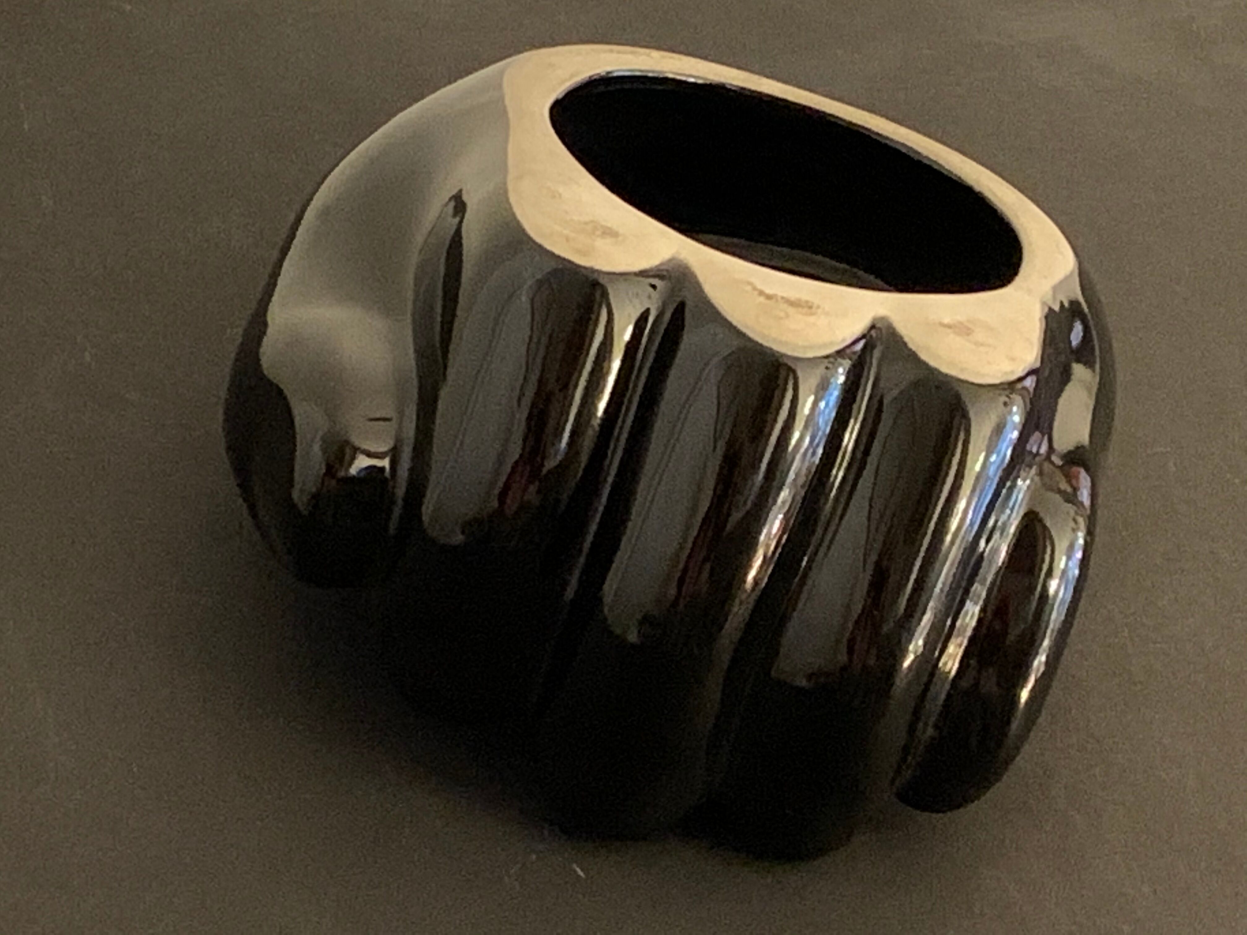 Black ceramic ashtray left hand