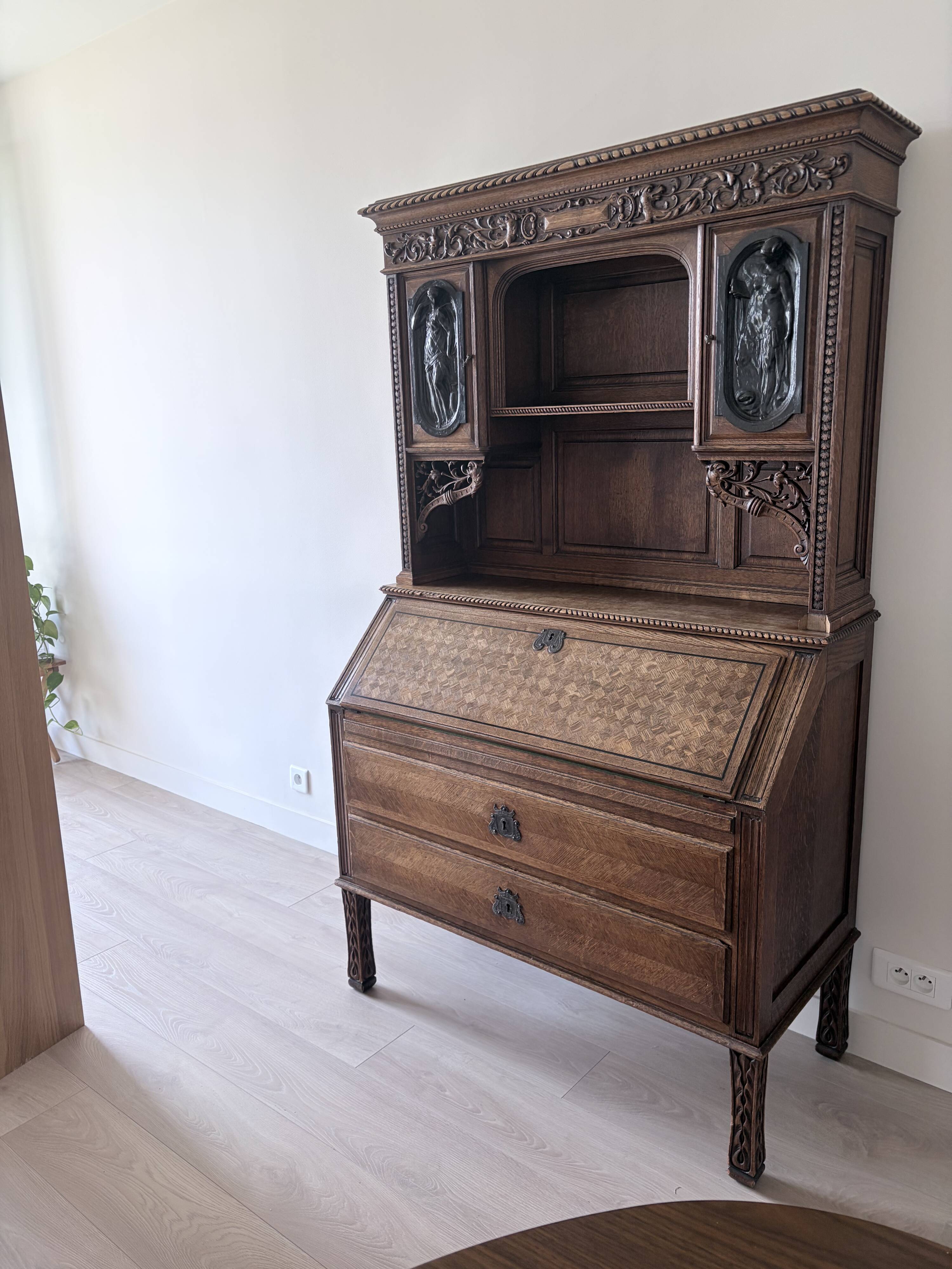 Large secretary with a drop-down front in carved oak, neo-Renaissance style.