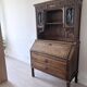 Large secretary with a drop-down front in carved oak, neo-Renaissance style.