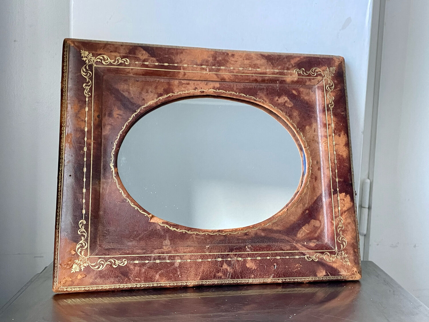 Antique leather framed mirror with gildings 30 cm x  24 cm