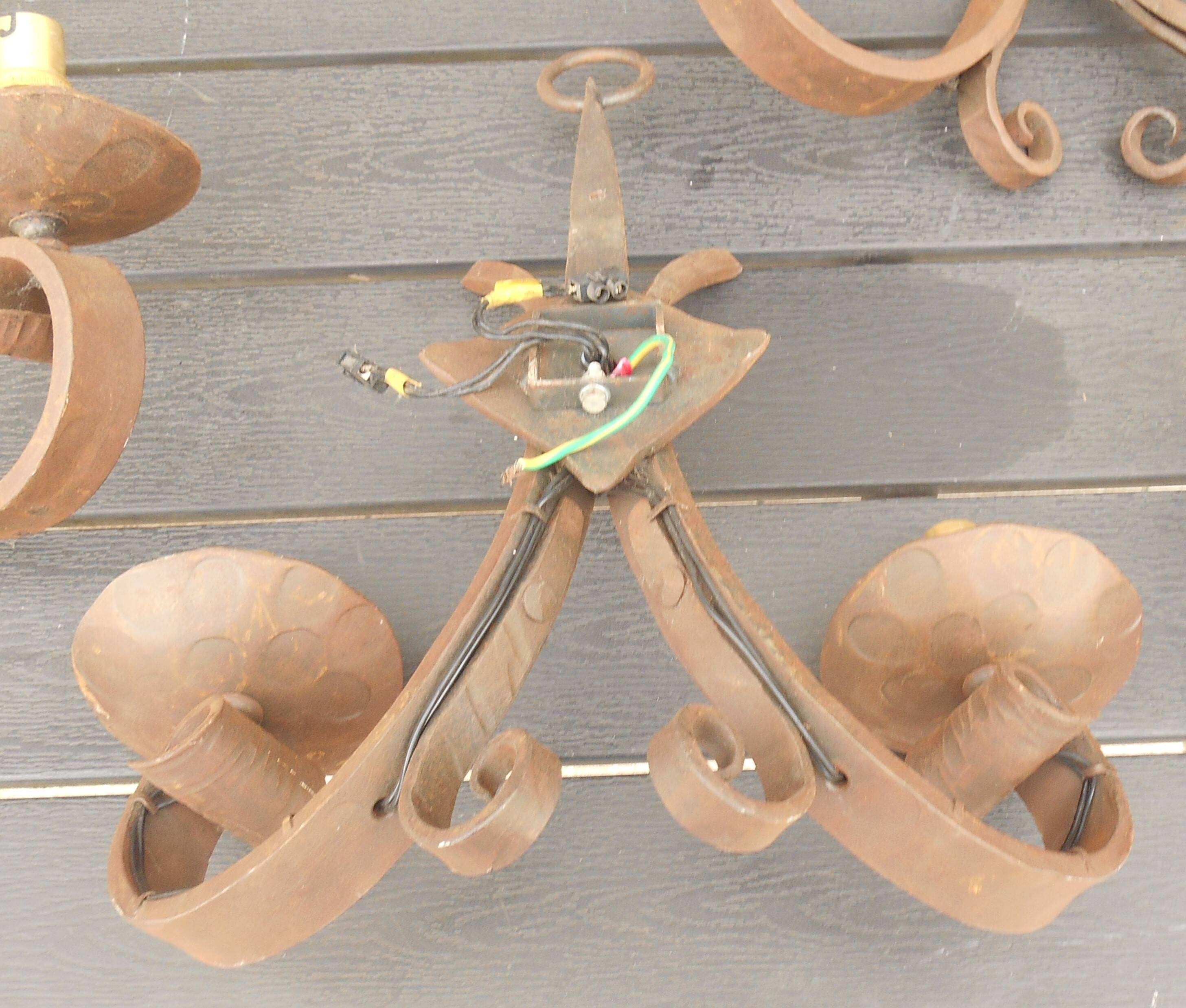 Four antique wrought iron wall lights