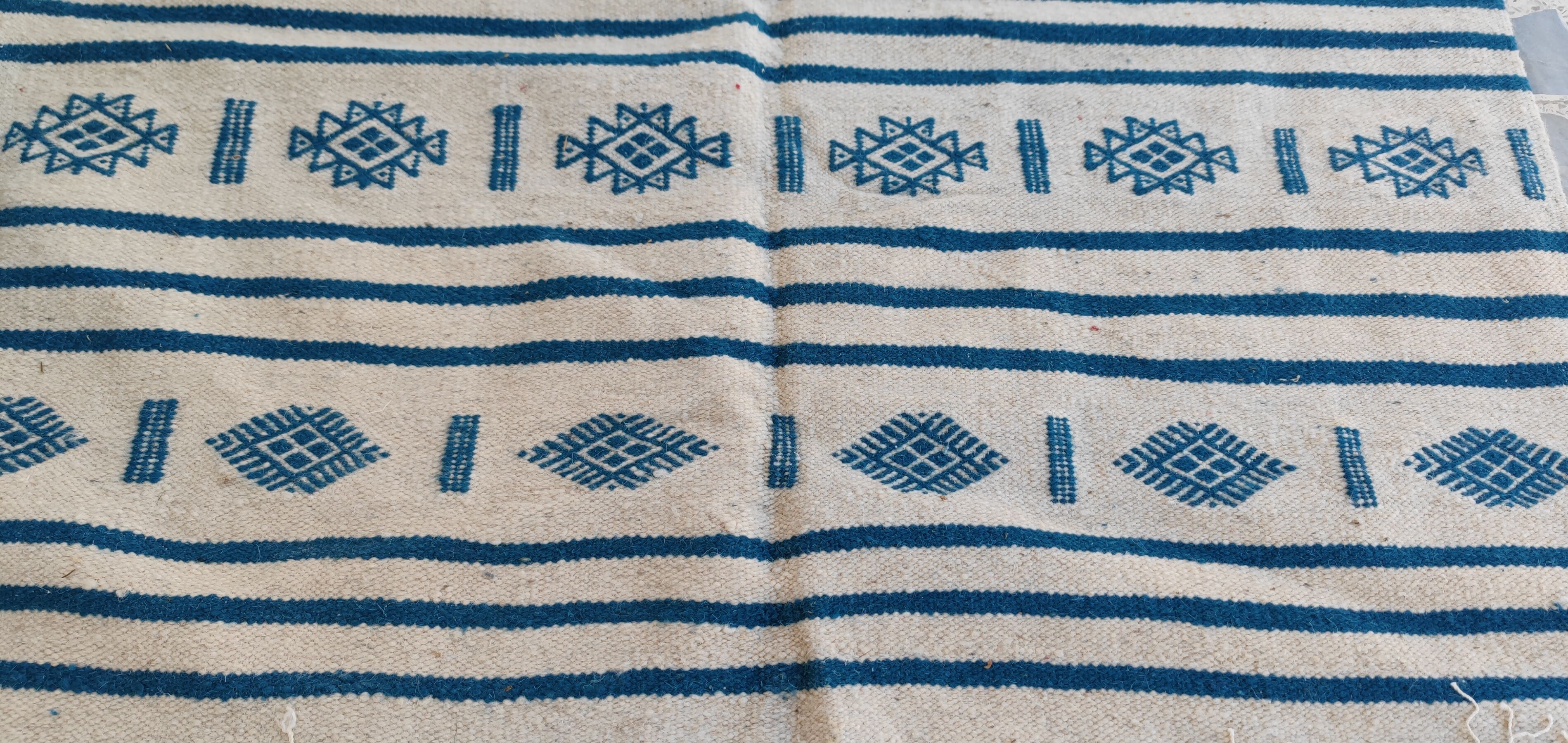 Traditional handmade white and blue kilim rug in natural wool