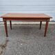 English wood coffee table with leather shelves