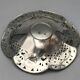 Silver-plated metal pocket emptier with openwork outline decoration