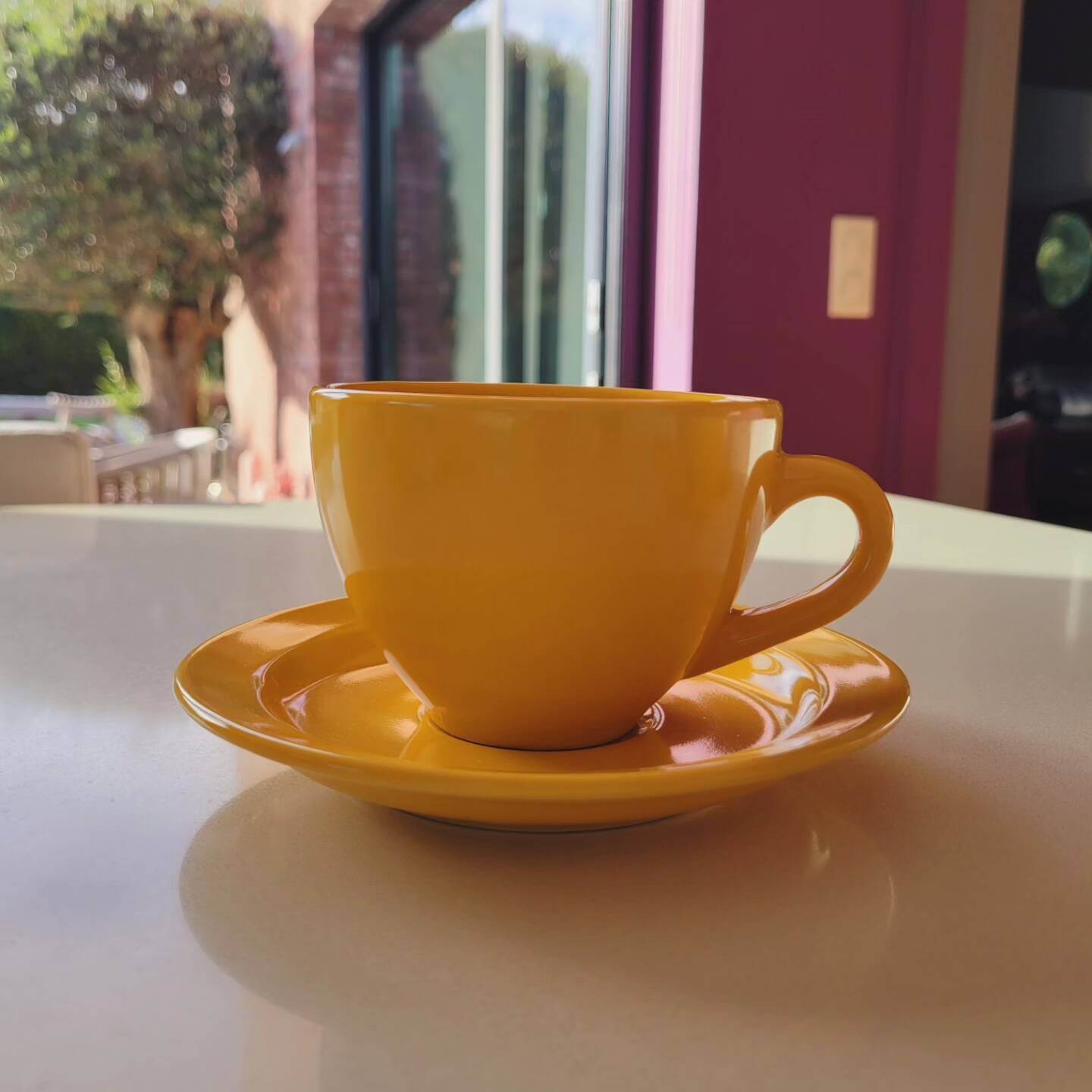 4 yellow cups and saucers