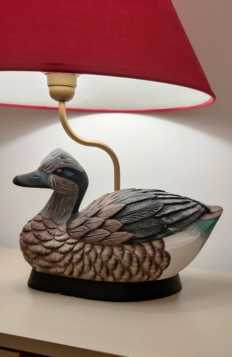 Decorative table lamp with a sculpted duck-shaped base and painted finish.