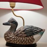 Decorative table lamp with a sculpted duck-shaped base and painted finish.