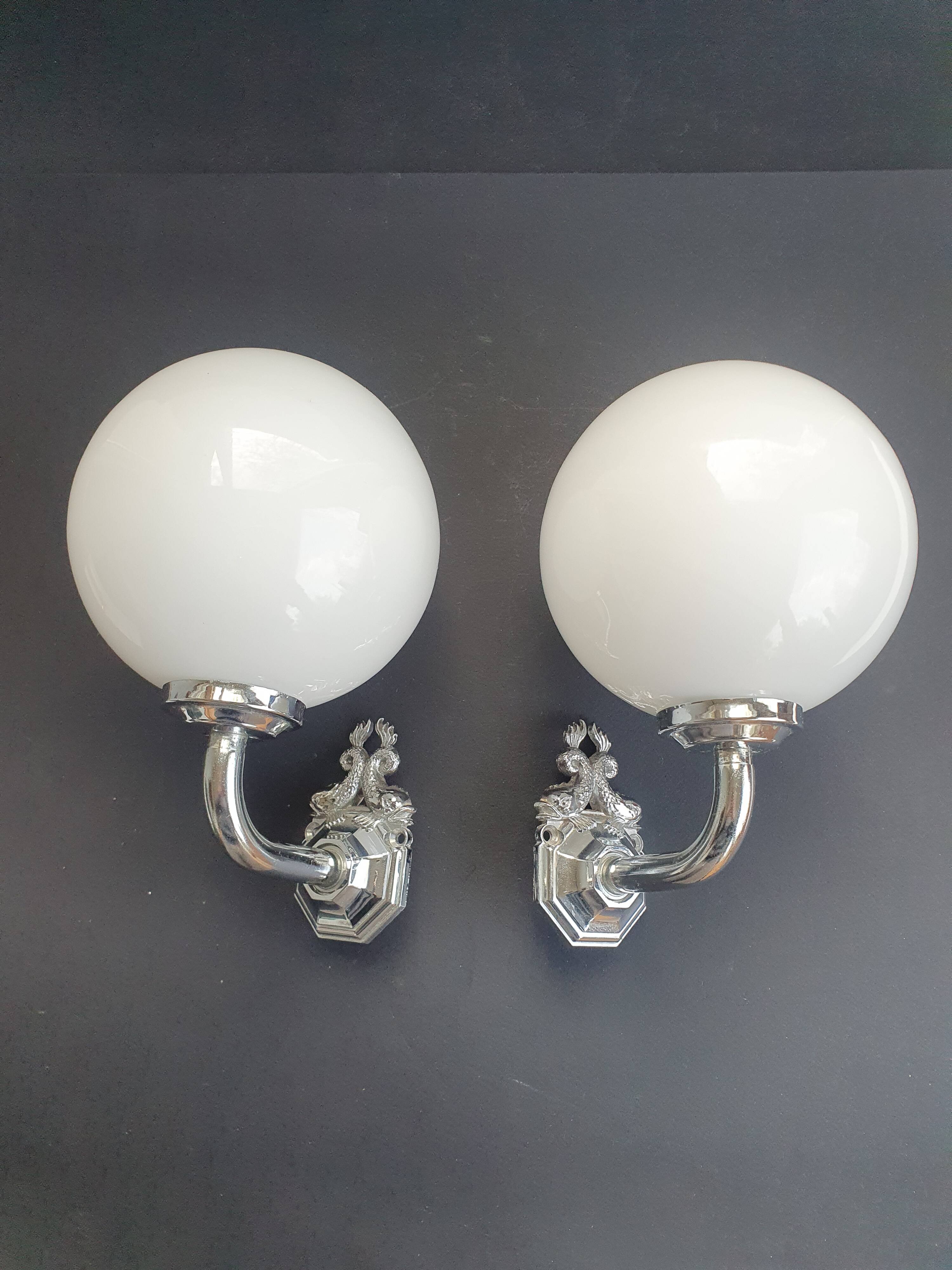 Pair of chrome wall sconces for bathroom with vintage fish pattern.
