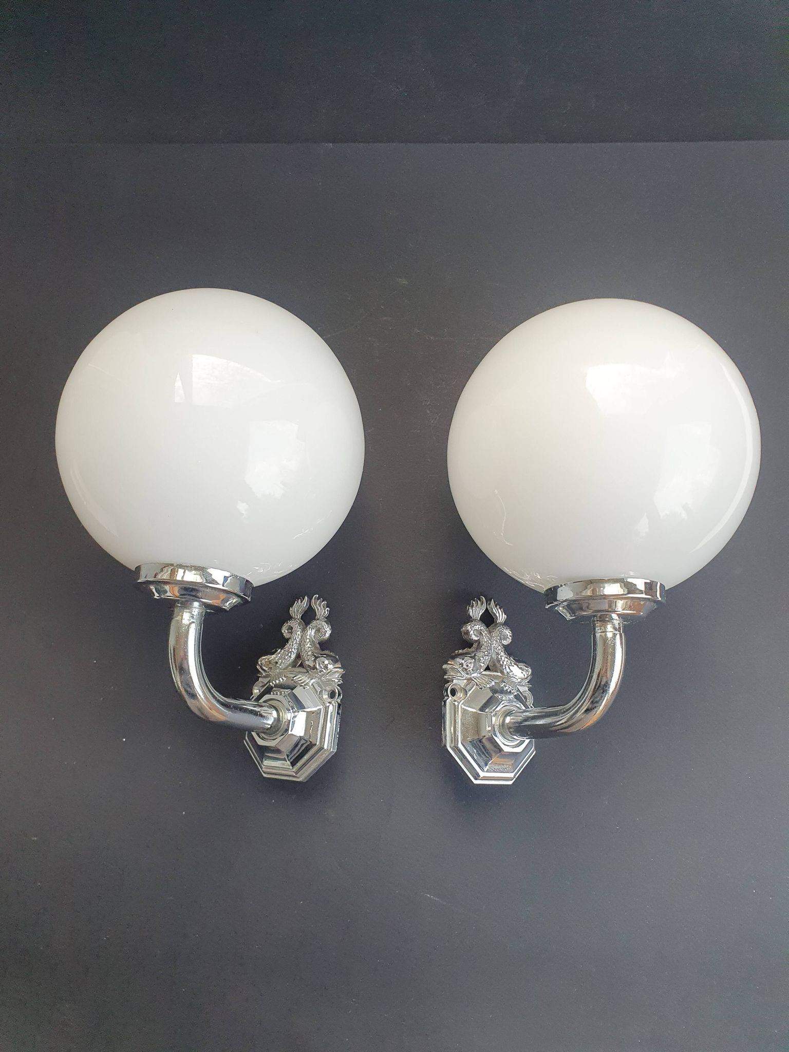 Pair of chrome wall sconces for bathroom with vintage fish pattern.