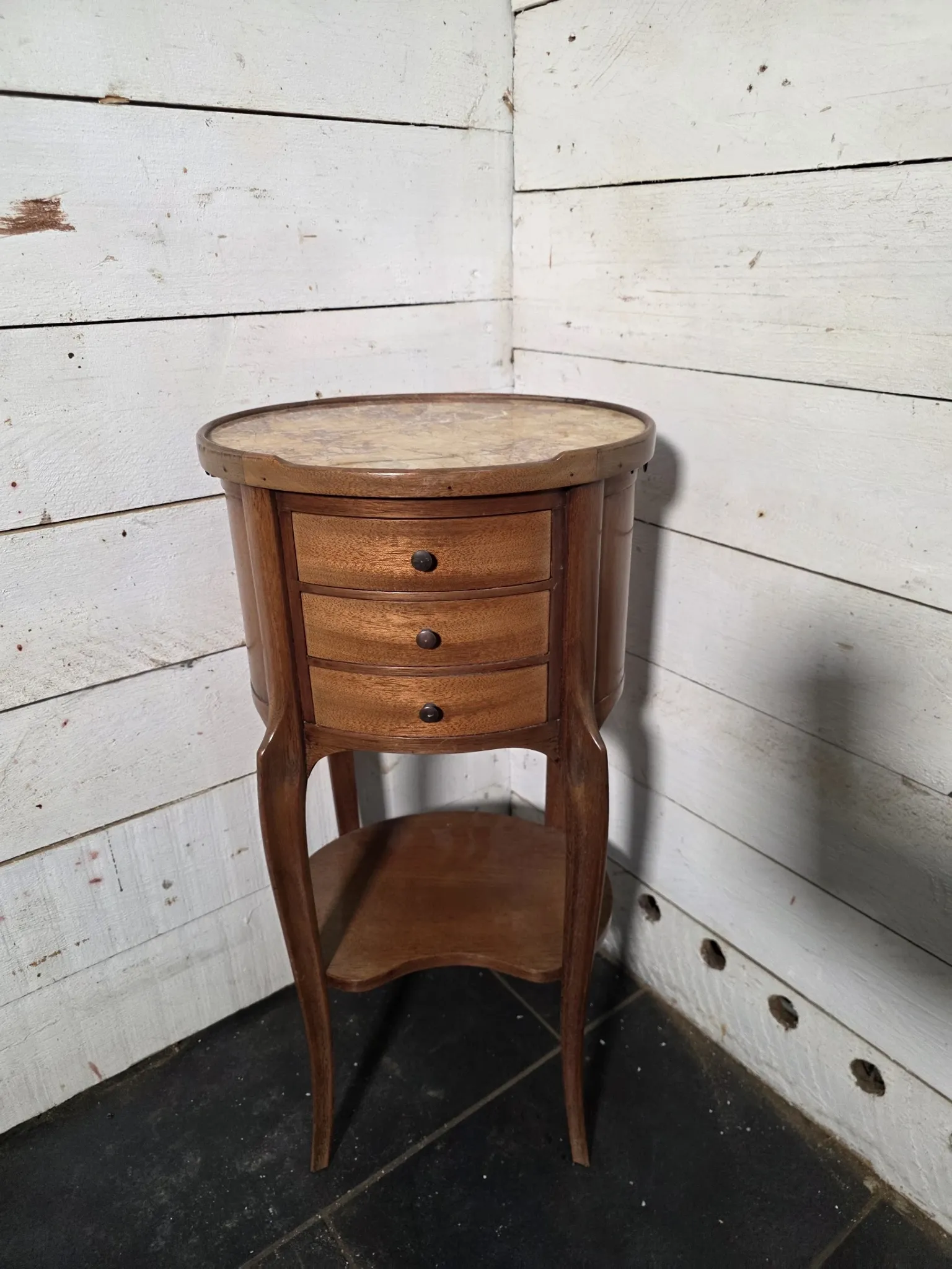 Oval bedside table in Louis XV style made of mahogany.