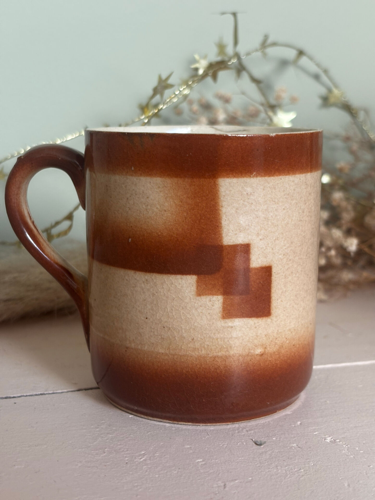 Vintage 70s old ceramic mug with a brown cubic graphic pattern.