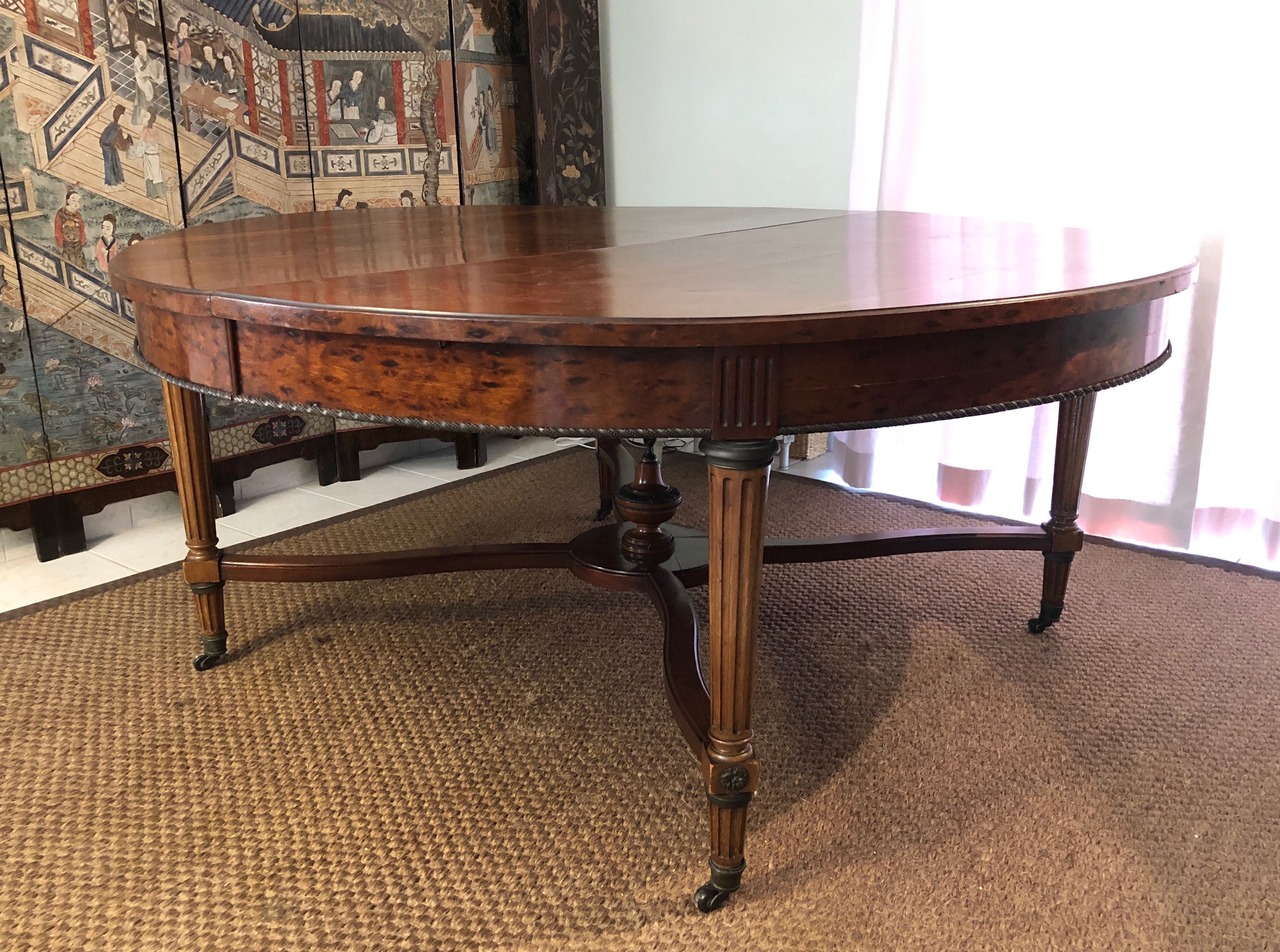 Important central pedestal table in mahogany, brass and bronze that can form a large dining table.