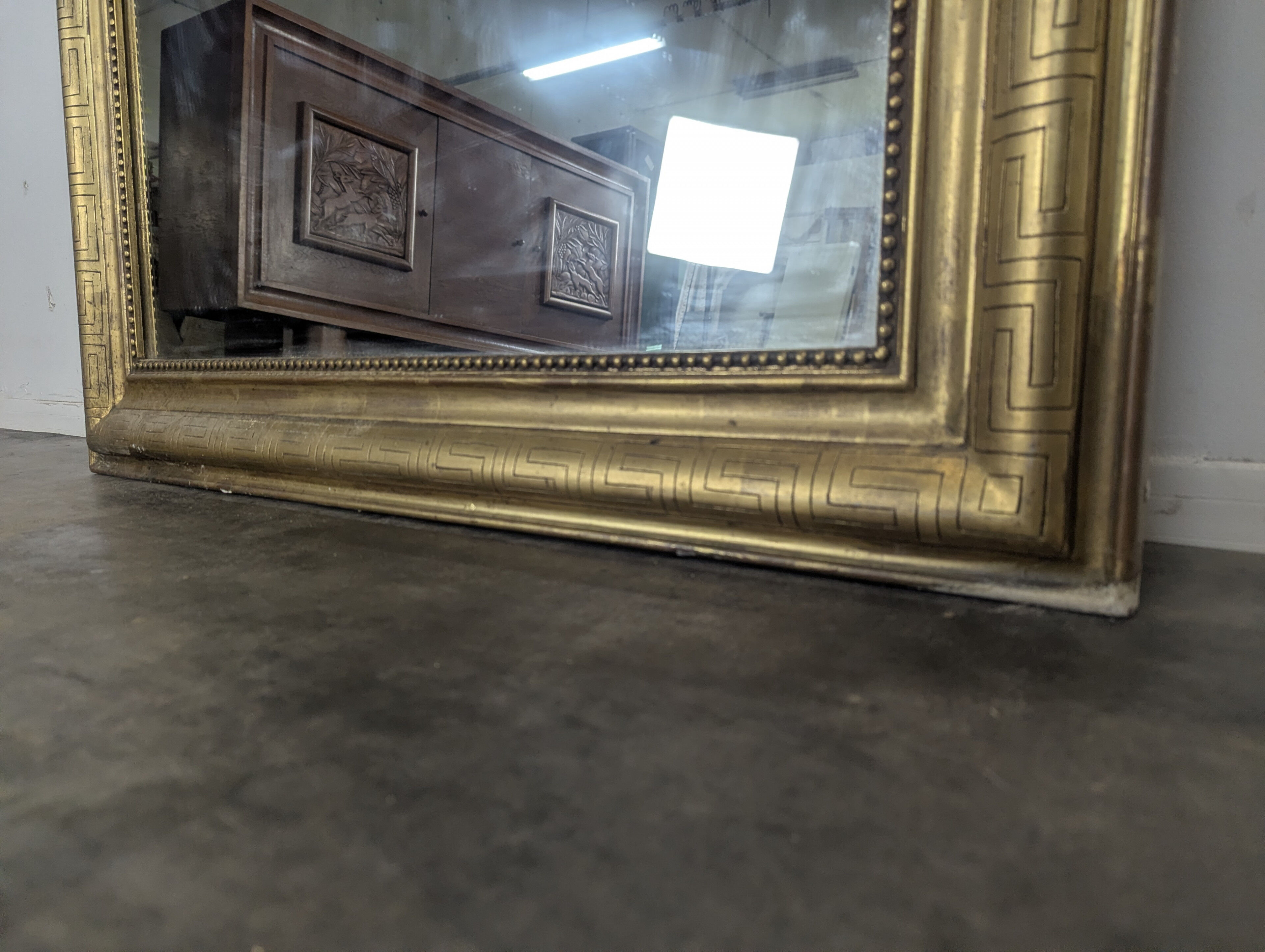 Golden wooden mirror with antique frieze from the Louis Philippe period.