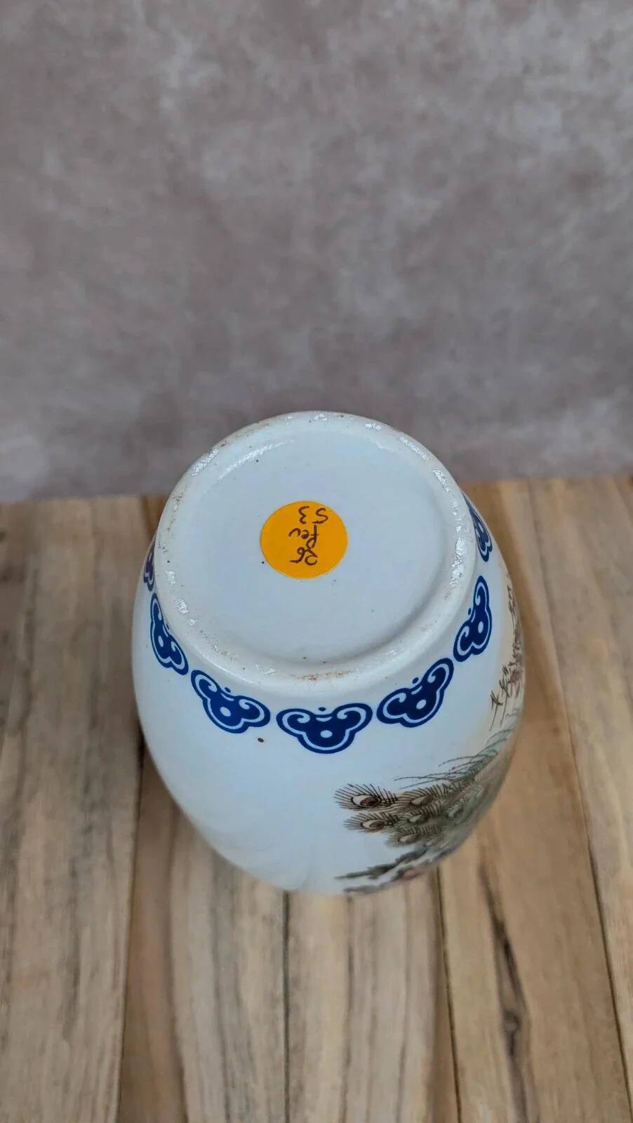 Asian vase decorated with peacock in porcelain