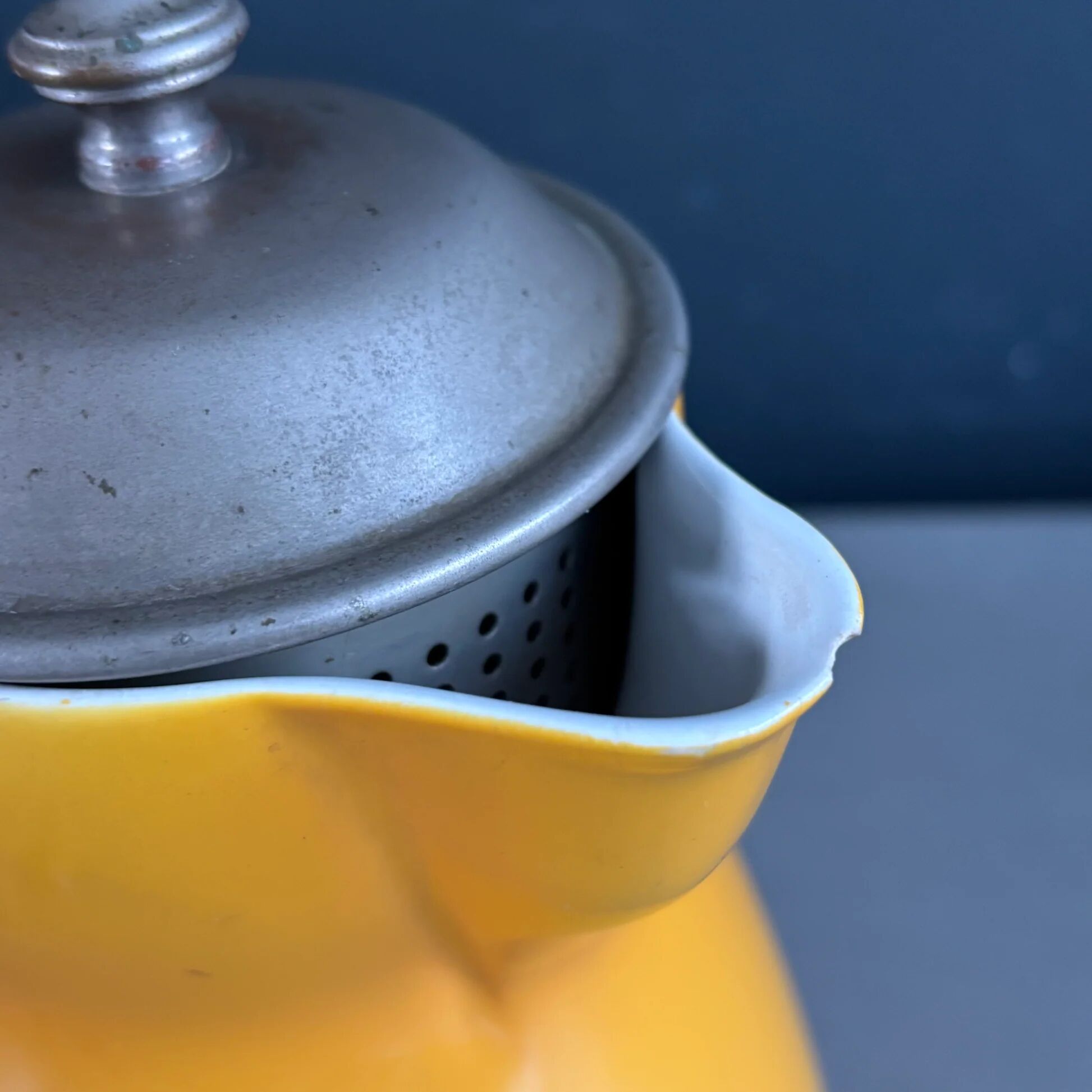 Antique teapot in earthenware with a tin filter lid.