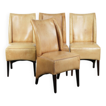 Set of four cowhide dining chairs with a comfortable seat and high back