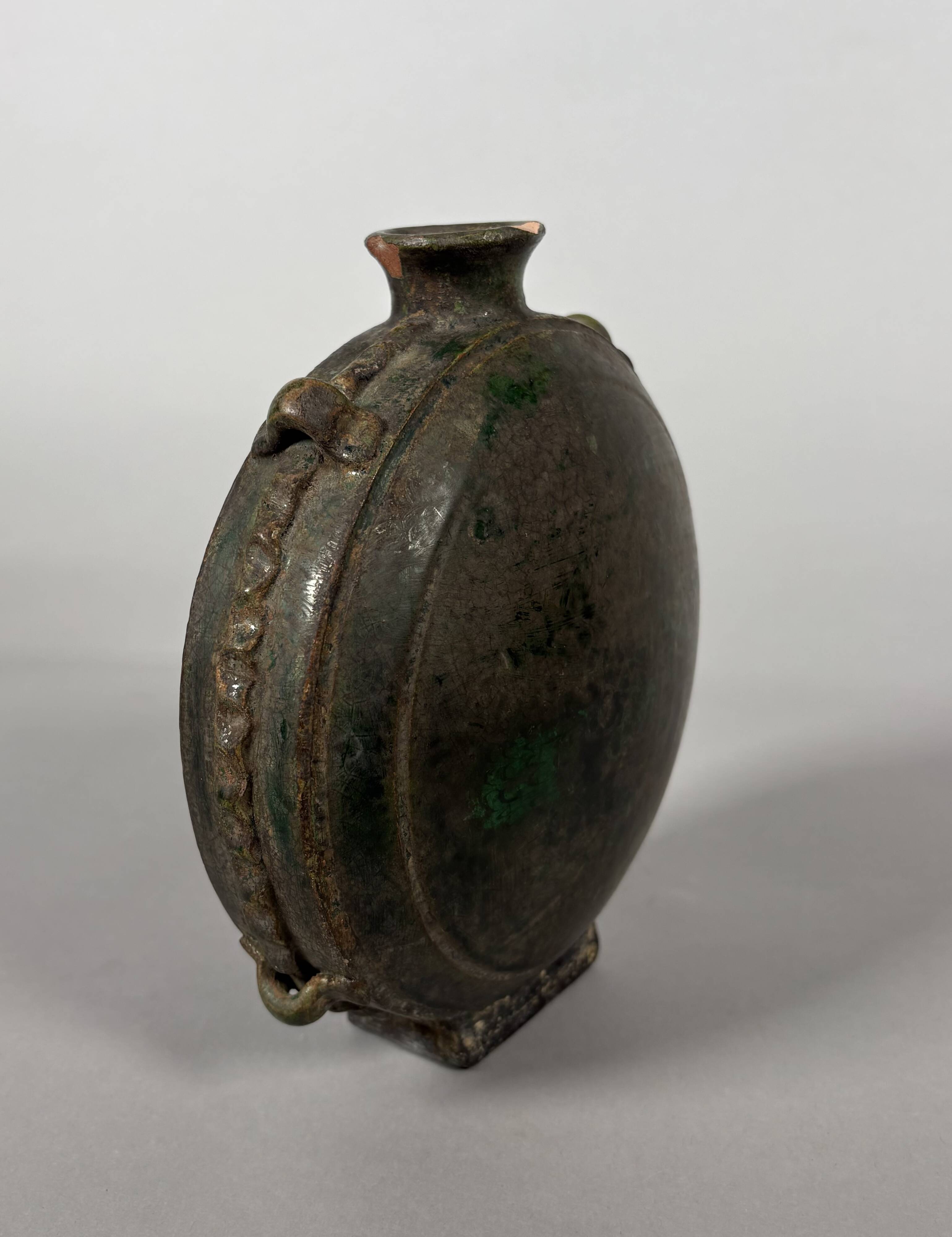 Nomadic rider's jug in green glazed earthenware, China, Tang Dynasty.