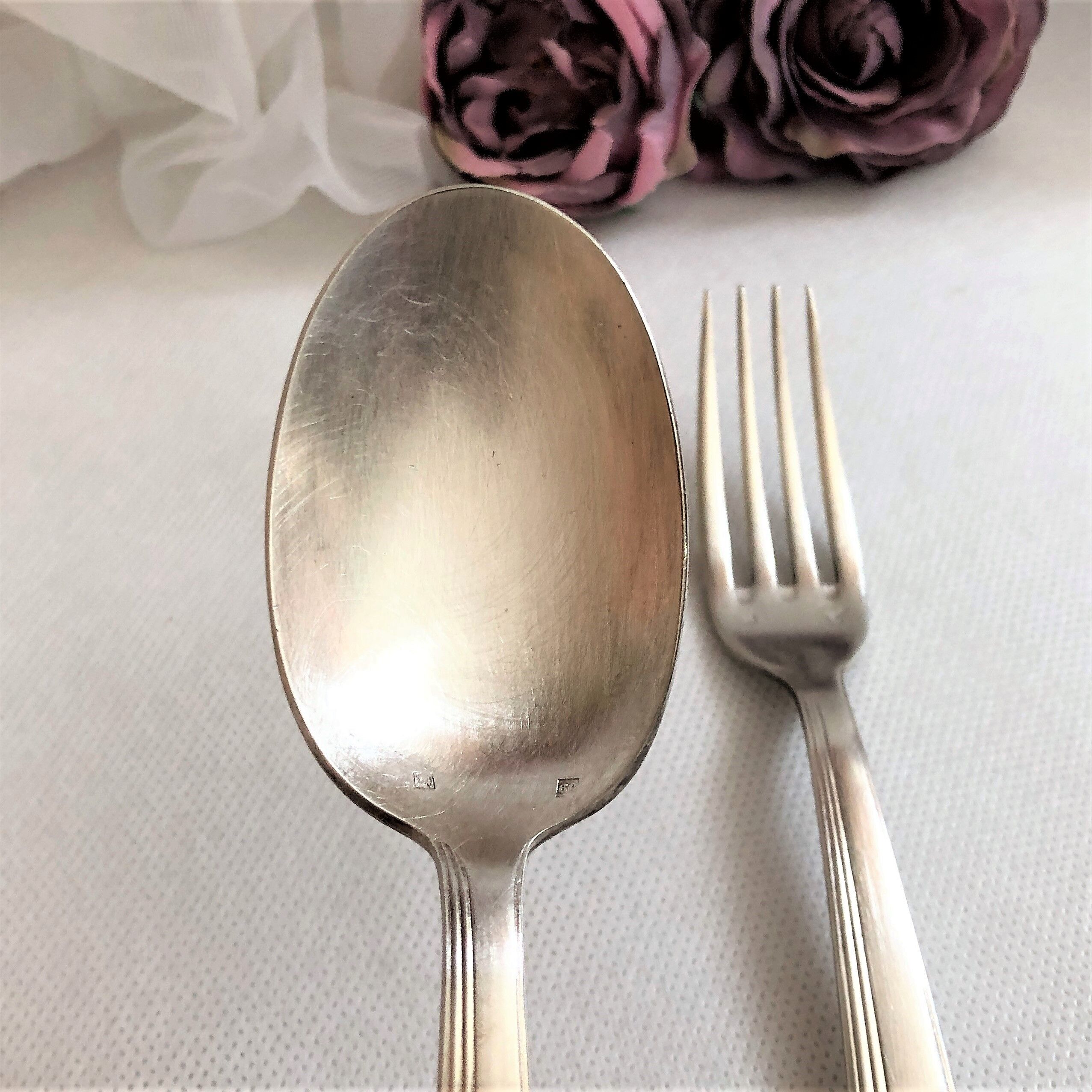 Set of 2 silver metal cutlery with punches