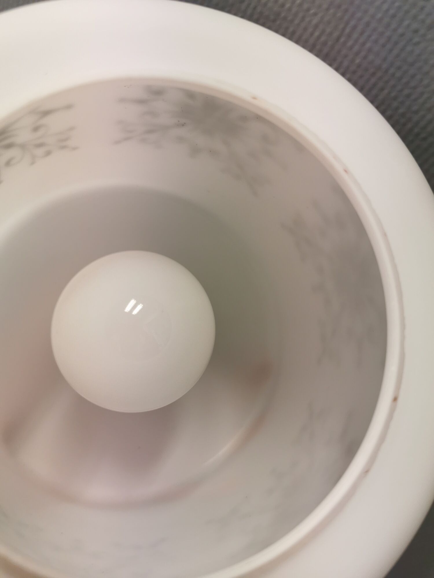 Scandinavian hanging lamp in white glass with inlayed black motifs.