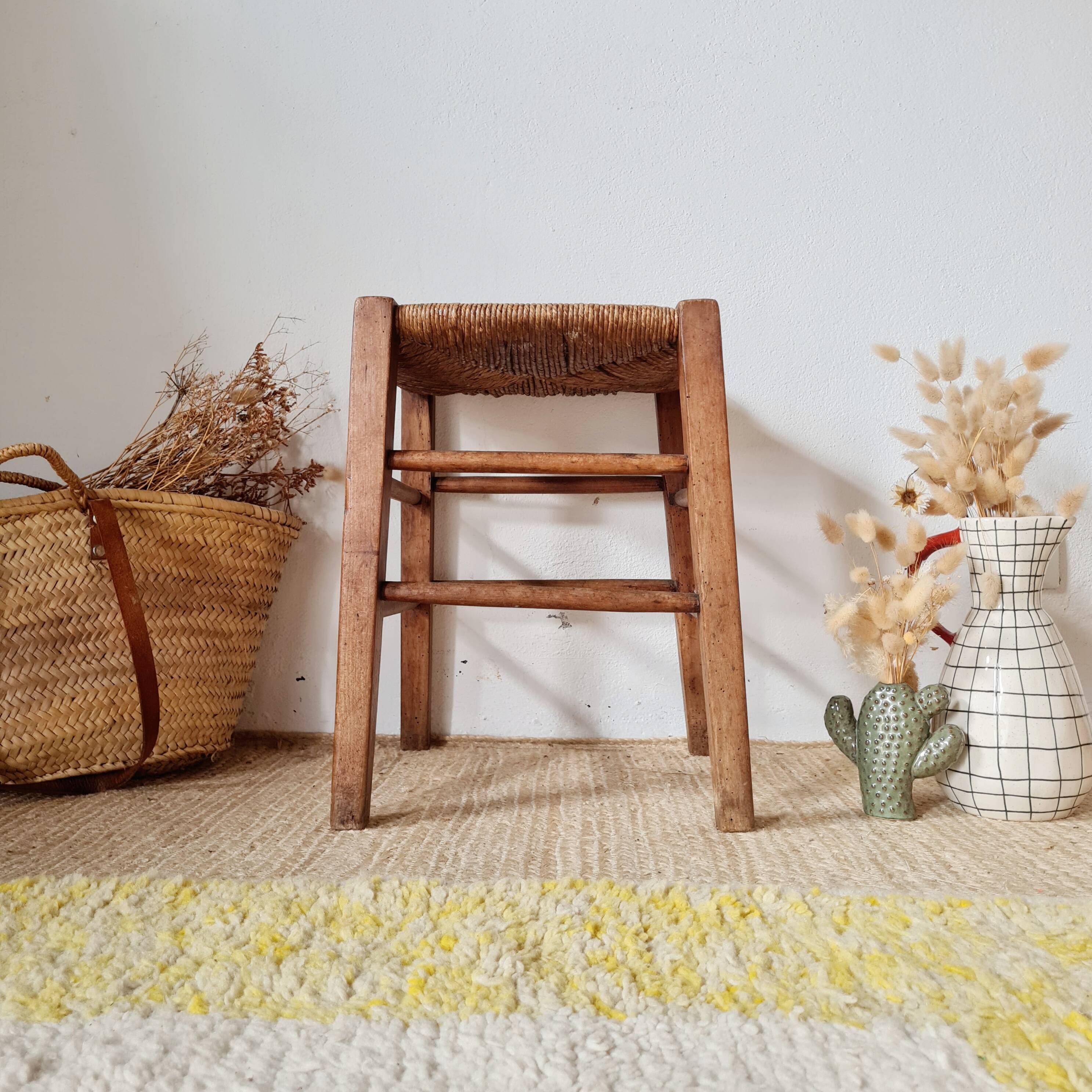 Old farmhouse stool made of wood and straw