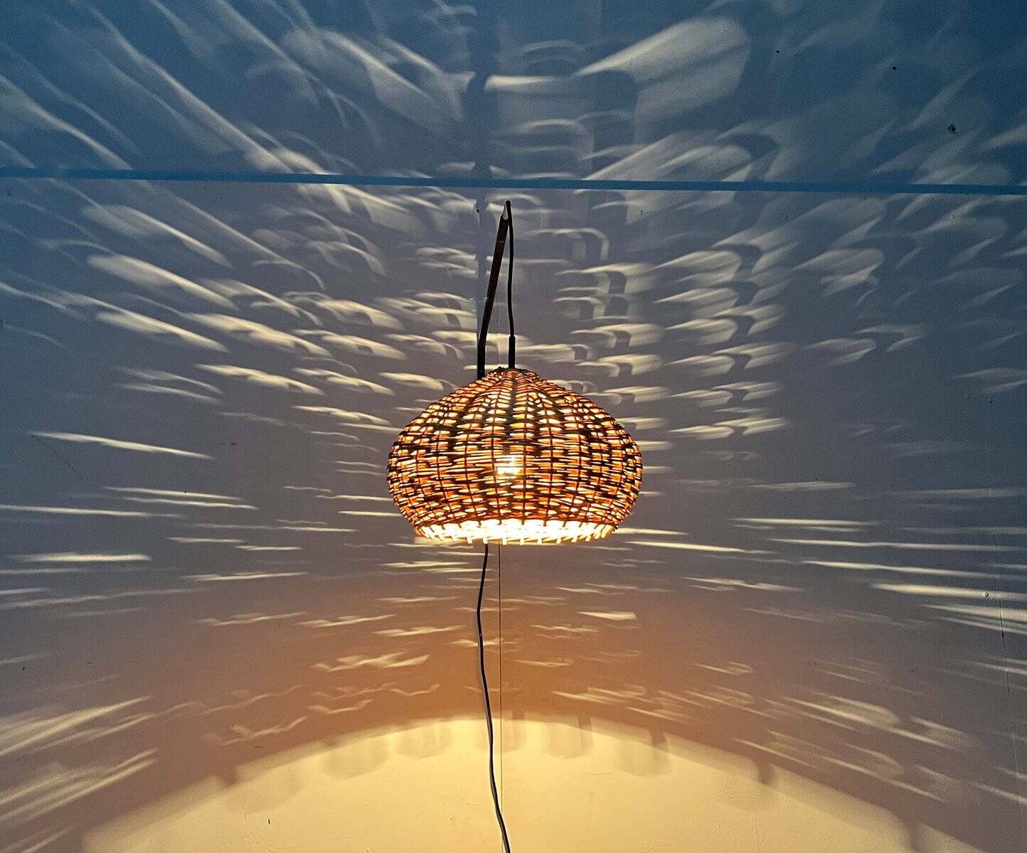 Mid-century modern Danish extendable cantilever wall lamp with a rattan shade, 1960s.