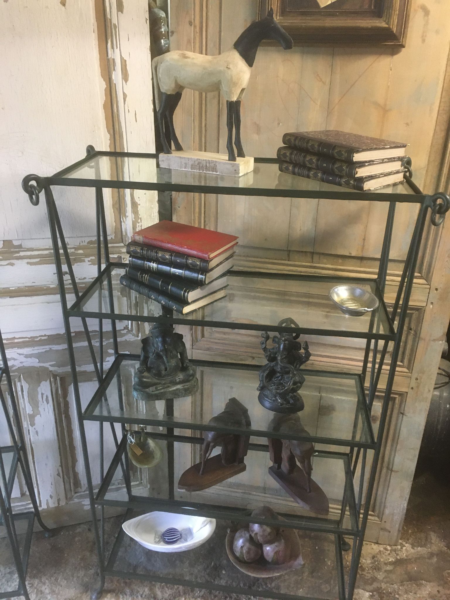 Pair of wrought iron and glass bookshelf shelves.