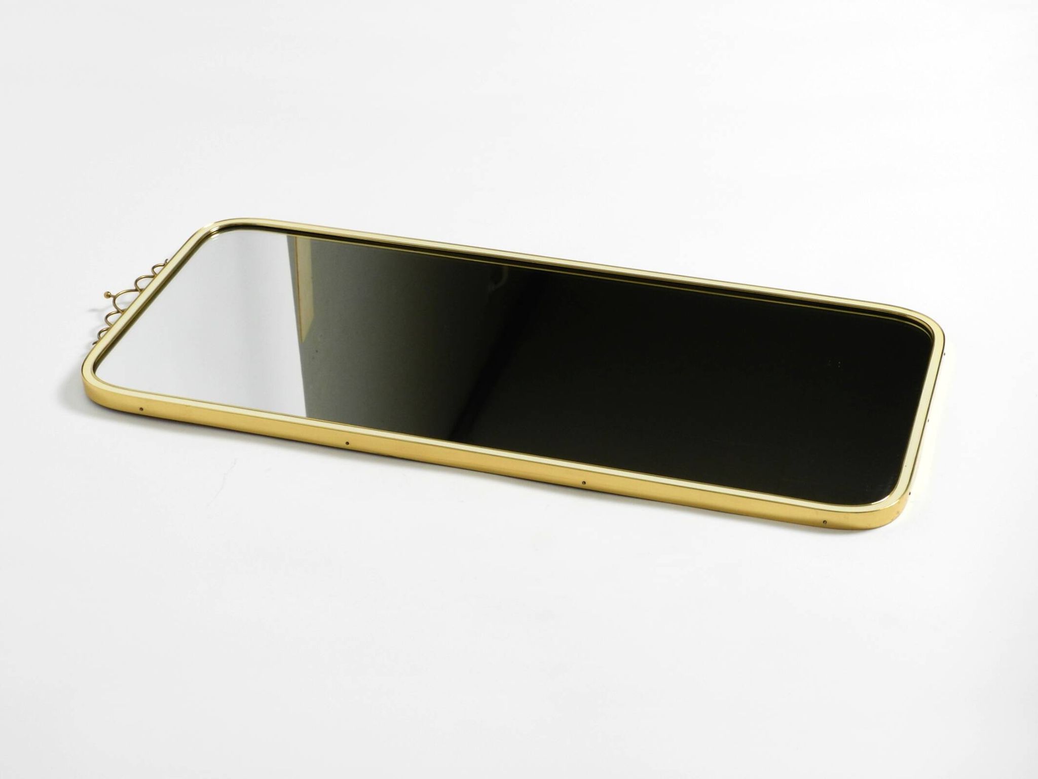 Large heavy long Mid Century brass wall mirror by Münchner Zierspiegel