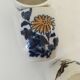 Set of three hand-painted porcelain cups with floral patterns.