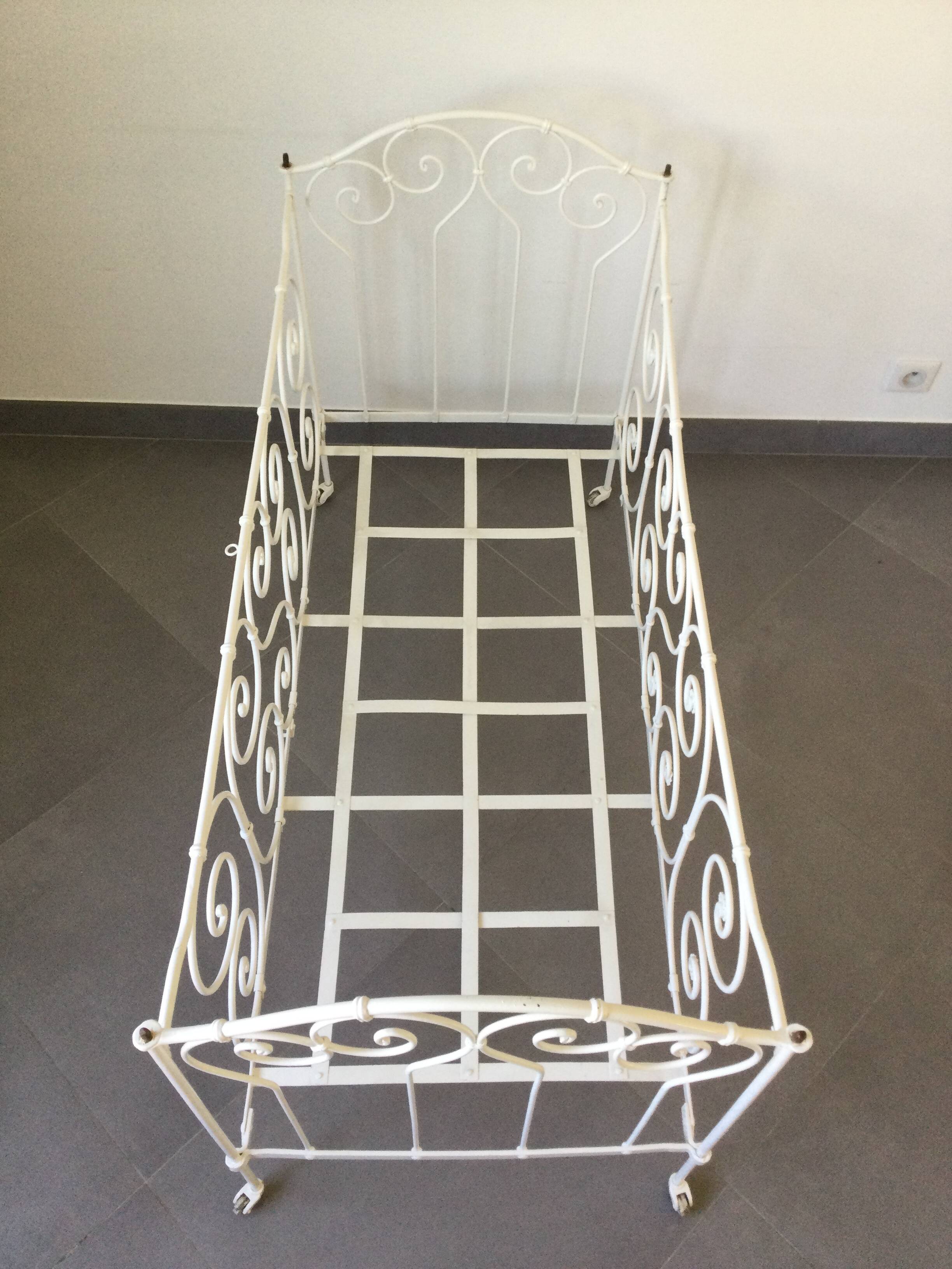 White wrought iron folding bed