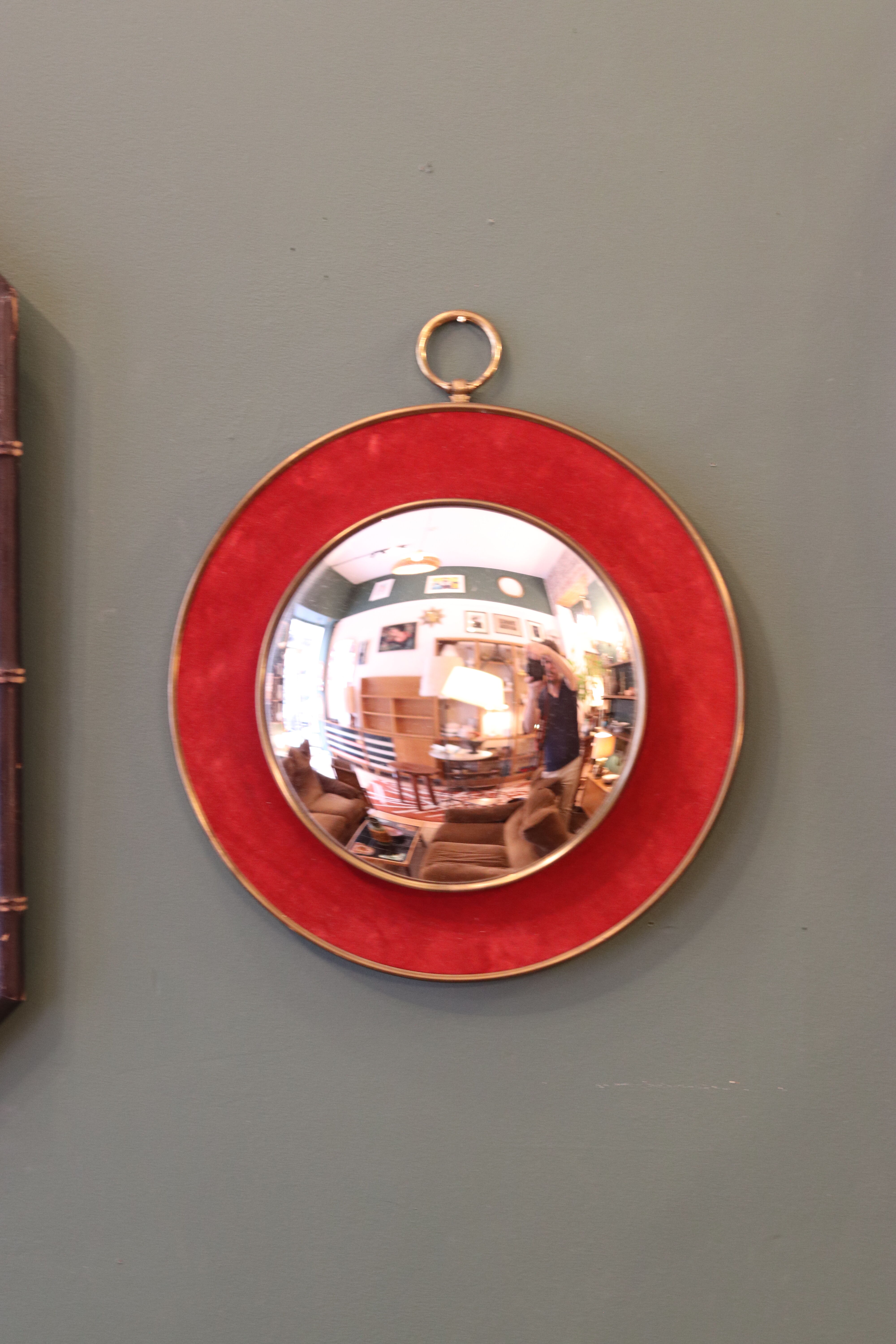 Witch's eye mirror in brass and red velvet