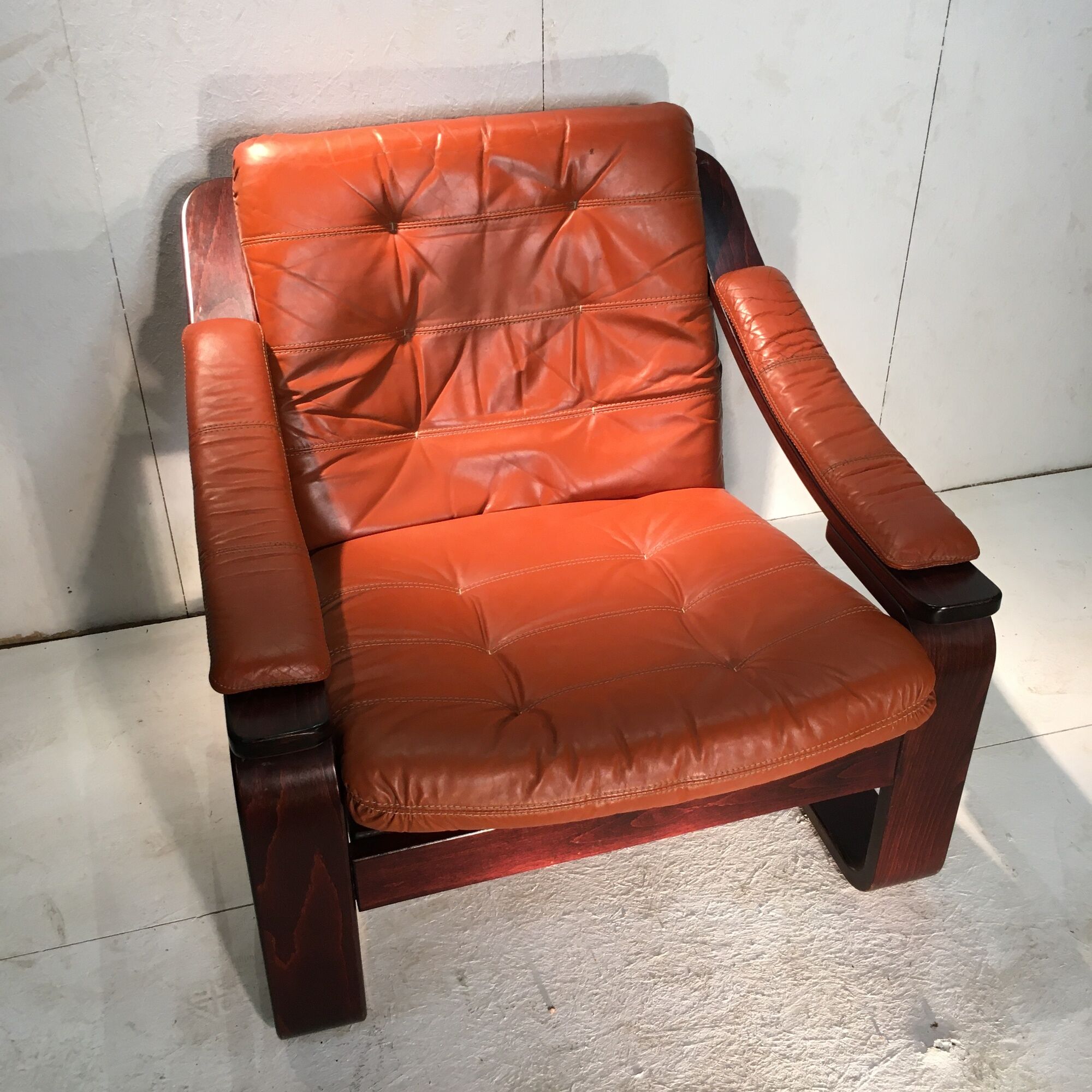 Duo of ochre leather and wood frame armchairs