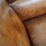 Sheepskin leather wingback armchair, with nails and black piping