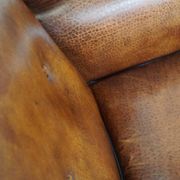 Sheepskin leather wingback armchair, with nails and black piping