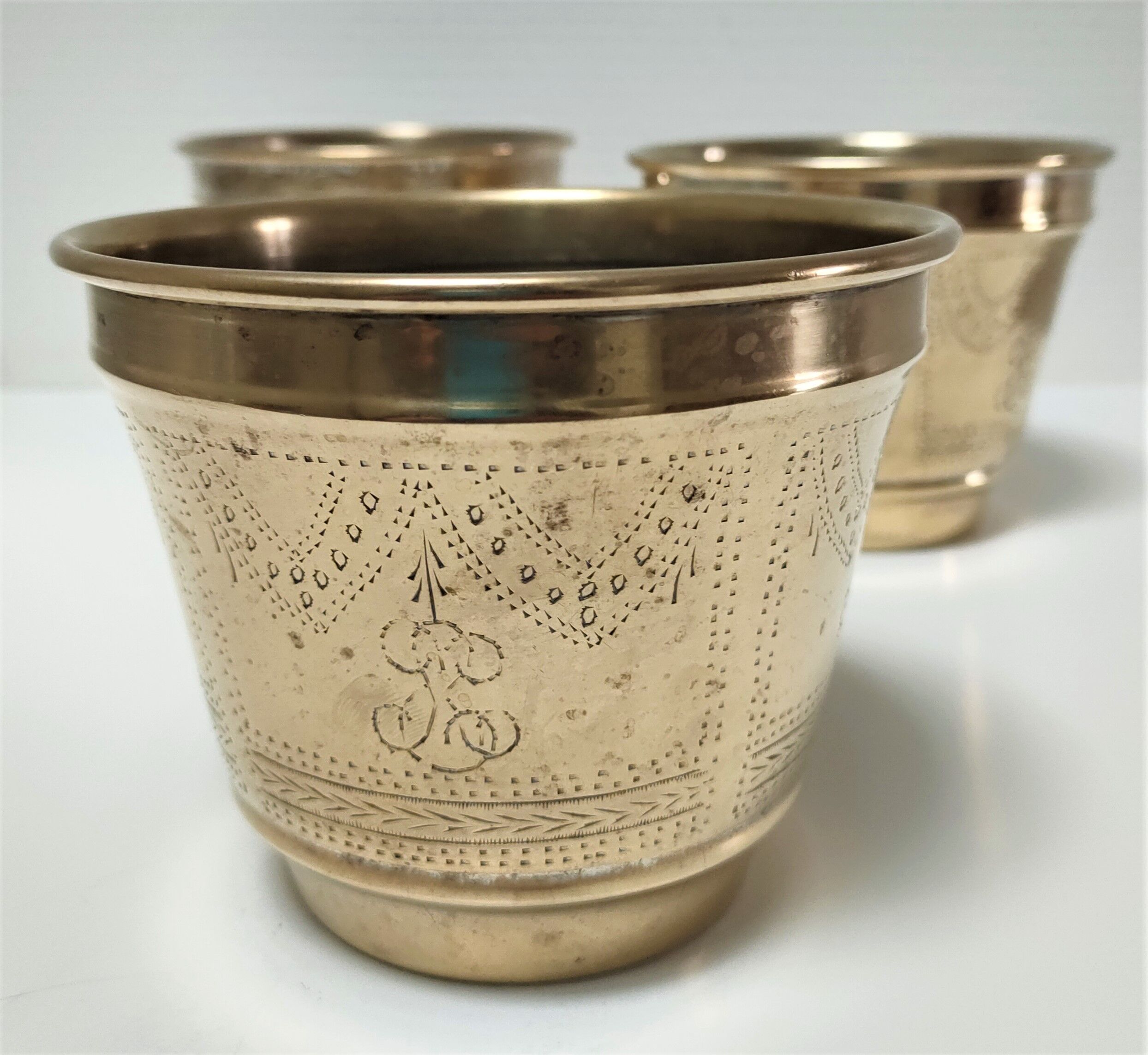 Three pot covers brass silver cover golden patina monogram early twentieth century