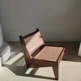 Reclined armchair in canned teak in natural wood