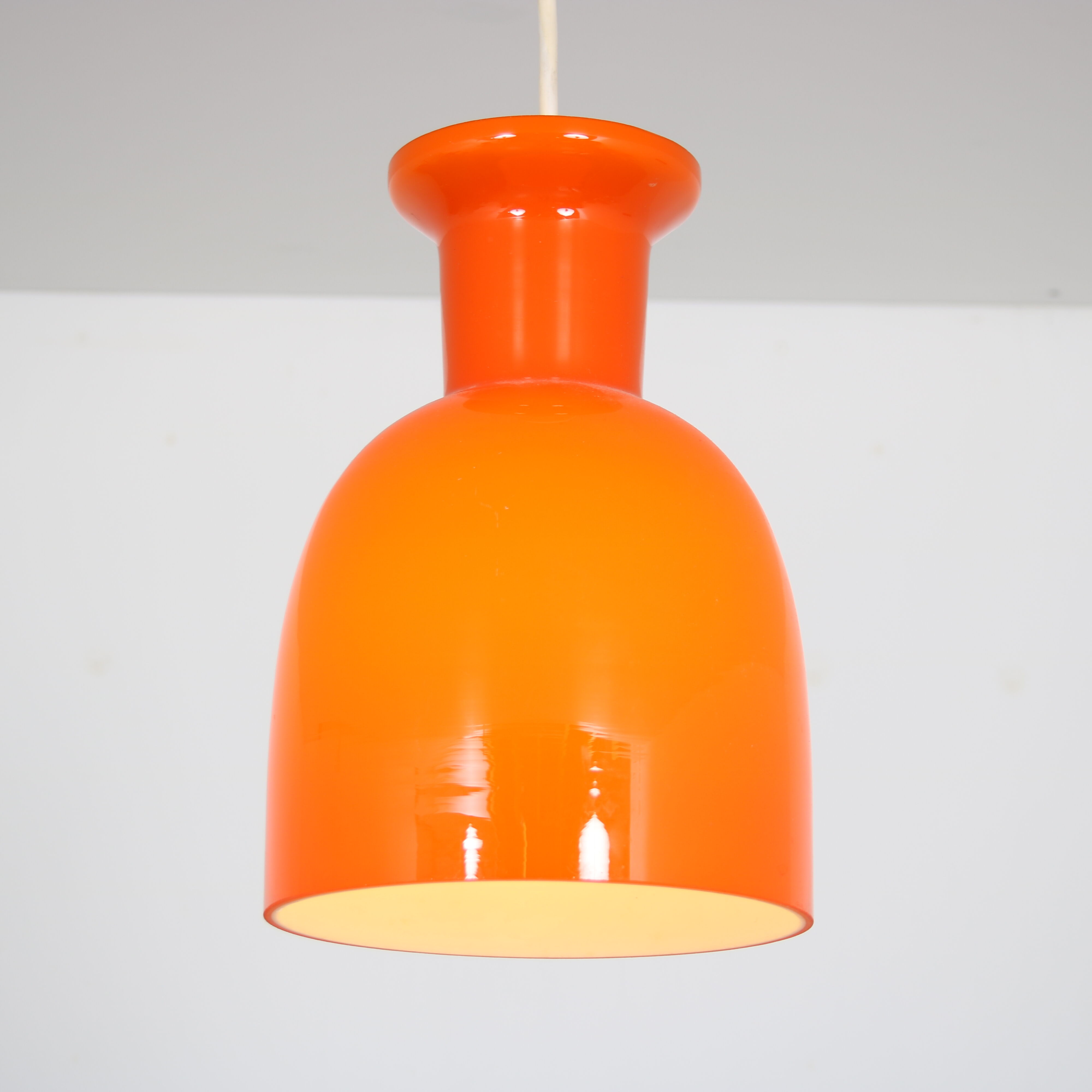 Pair of orange hanging lamps by Raak, the Netherlands, 1970