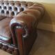 Vintage three-seater brown leather Chesterfield sofa