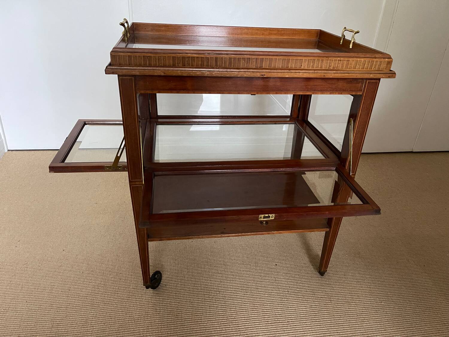 Serving Light mahogany English tea table. Beveled windows. circa 1900. Removable glass top.