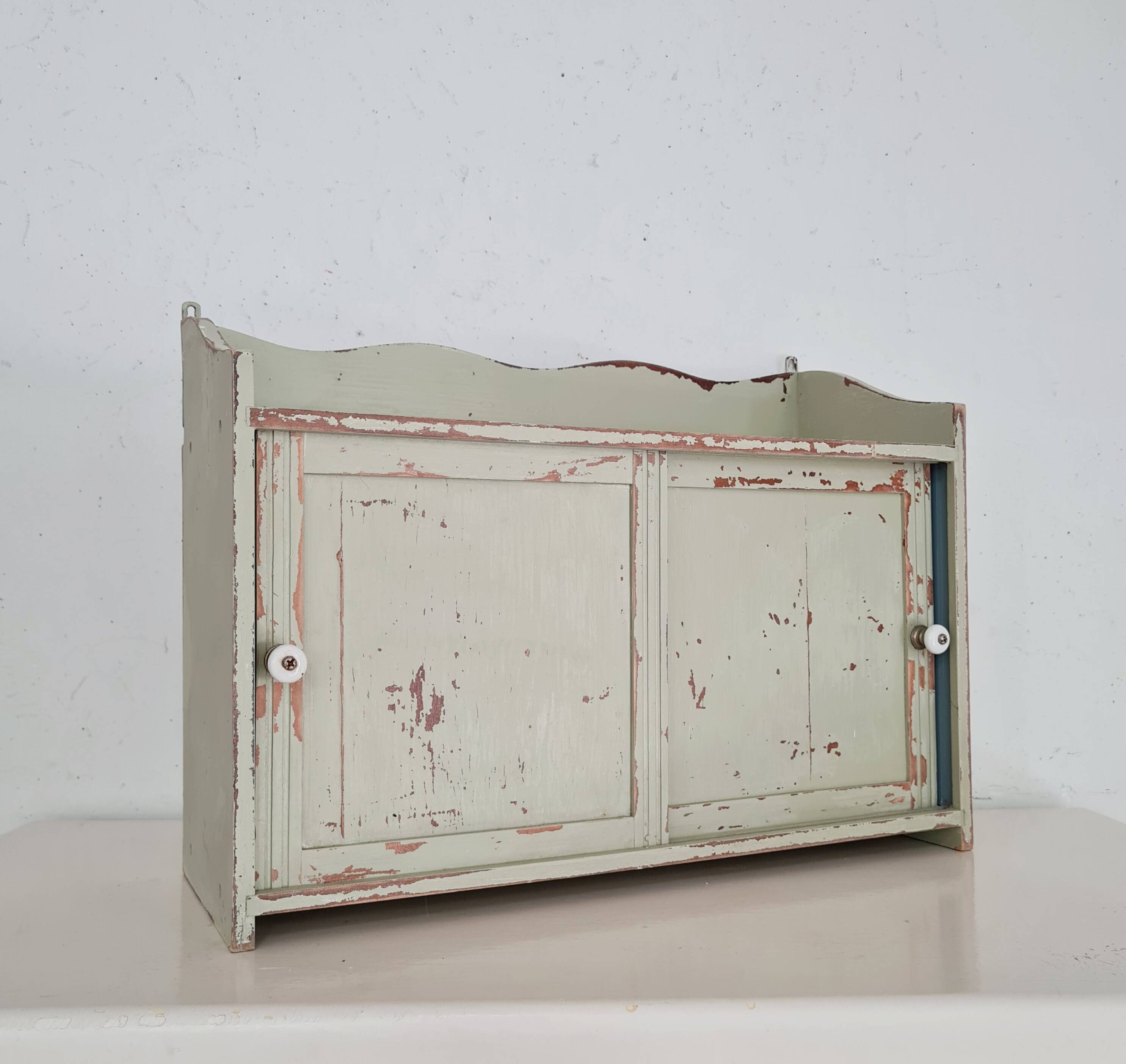 Small old wall shelf with sliding doors