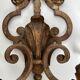 Pair of patinated wrought iron wall sconces with golden acanthus leaves and crystals.