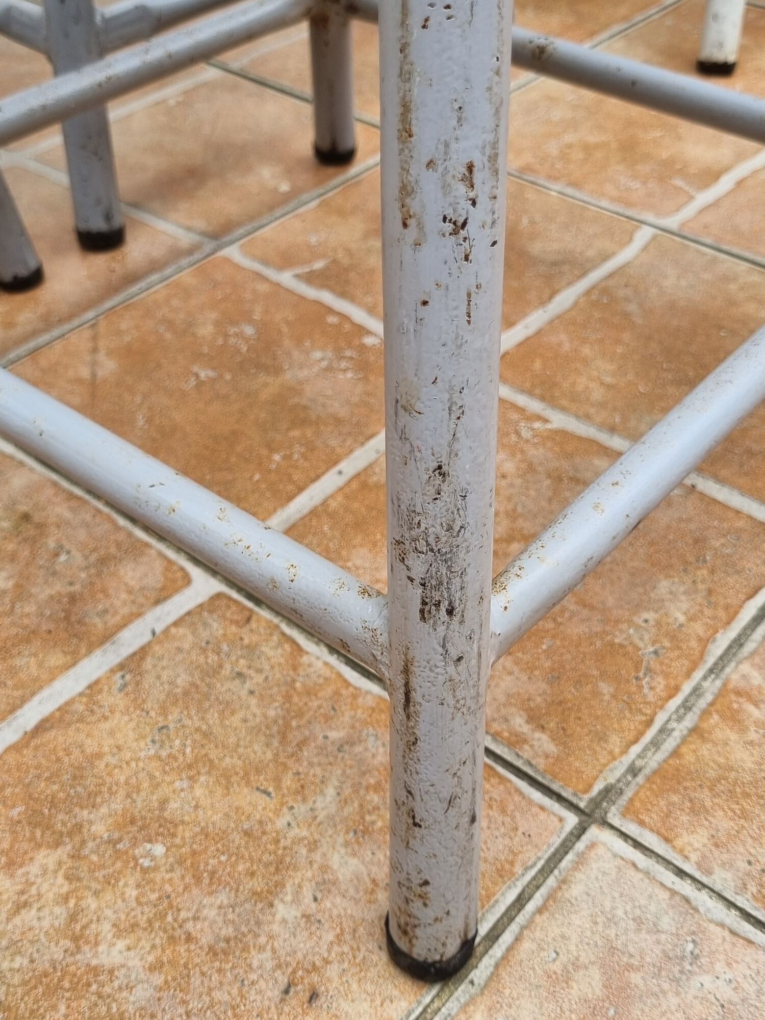 Set of four stackable industrial tubular metal and wood stools