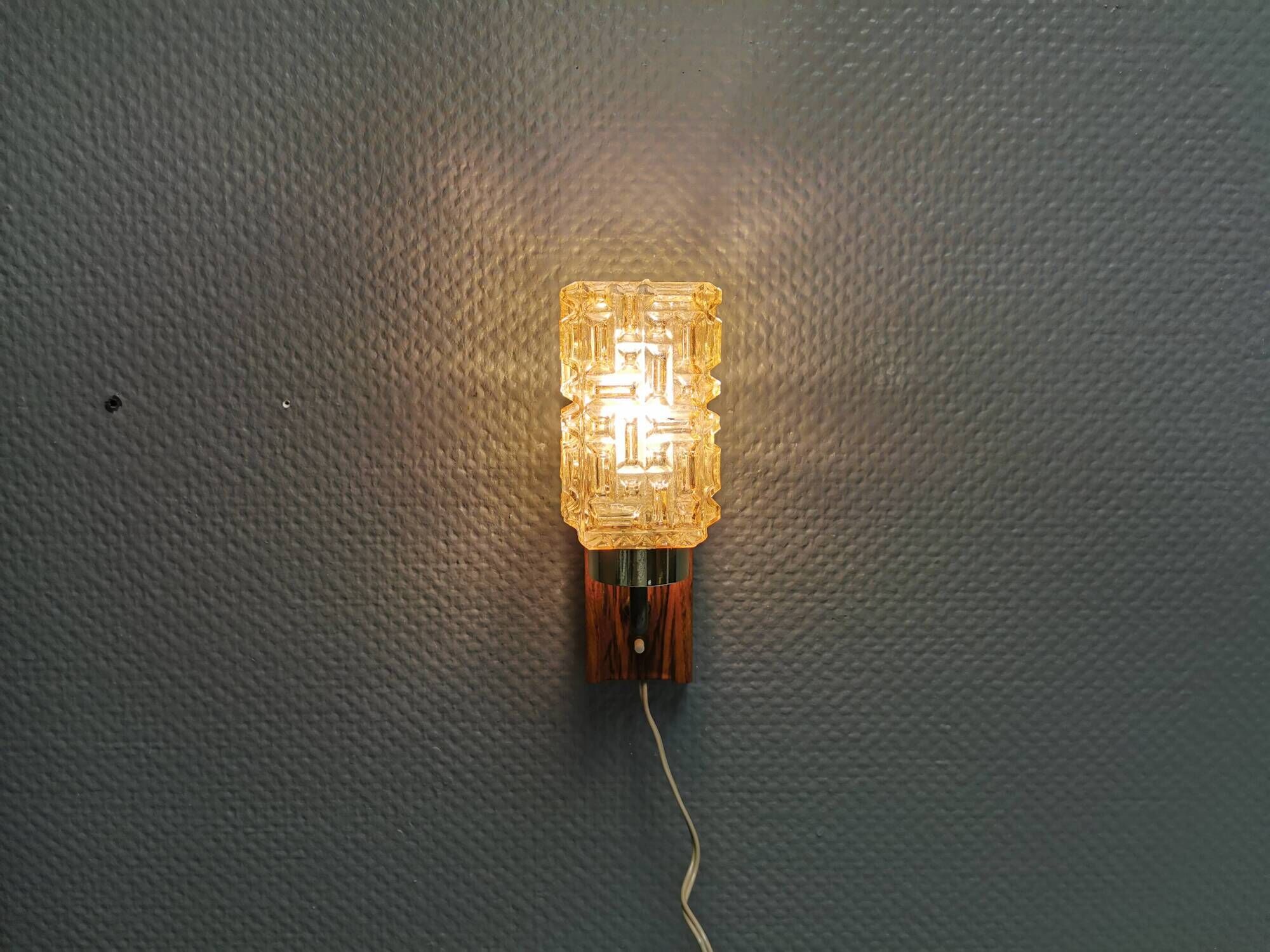 Small, stylish wall lamp with rosewood suspension and hard pressed glass