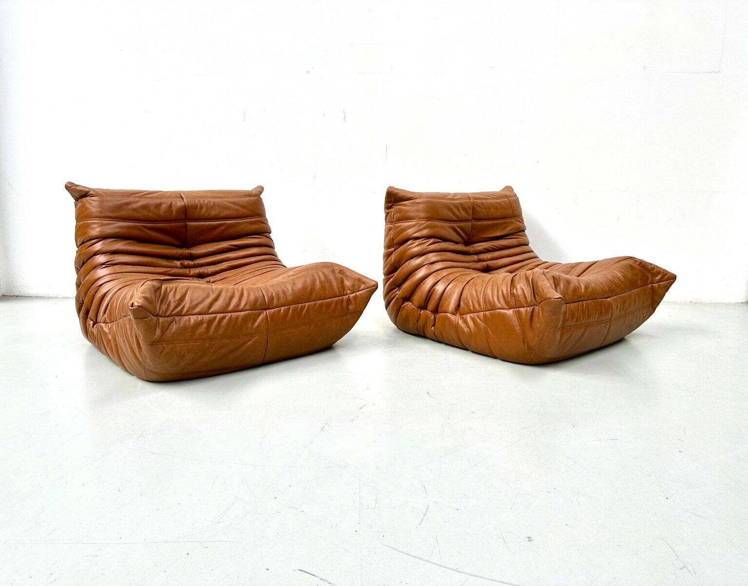 Togo lounge chairs in cognac cow leather attributed to Michel Ducaroy for Ligne Roset, set of 2