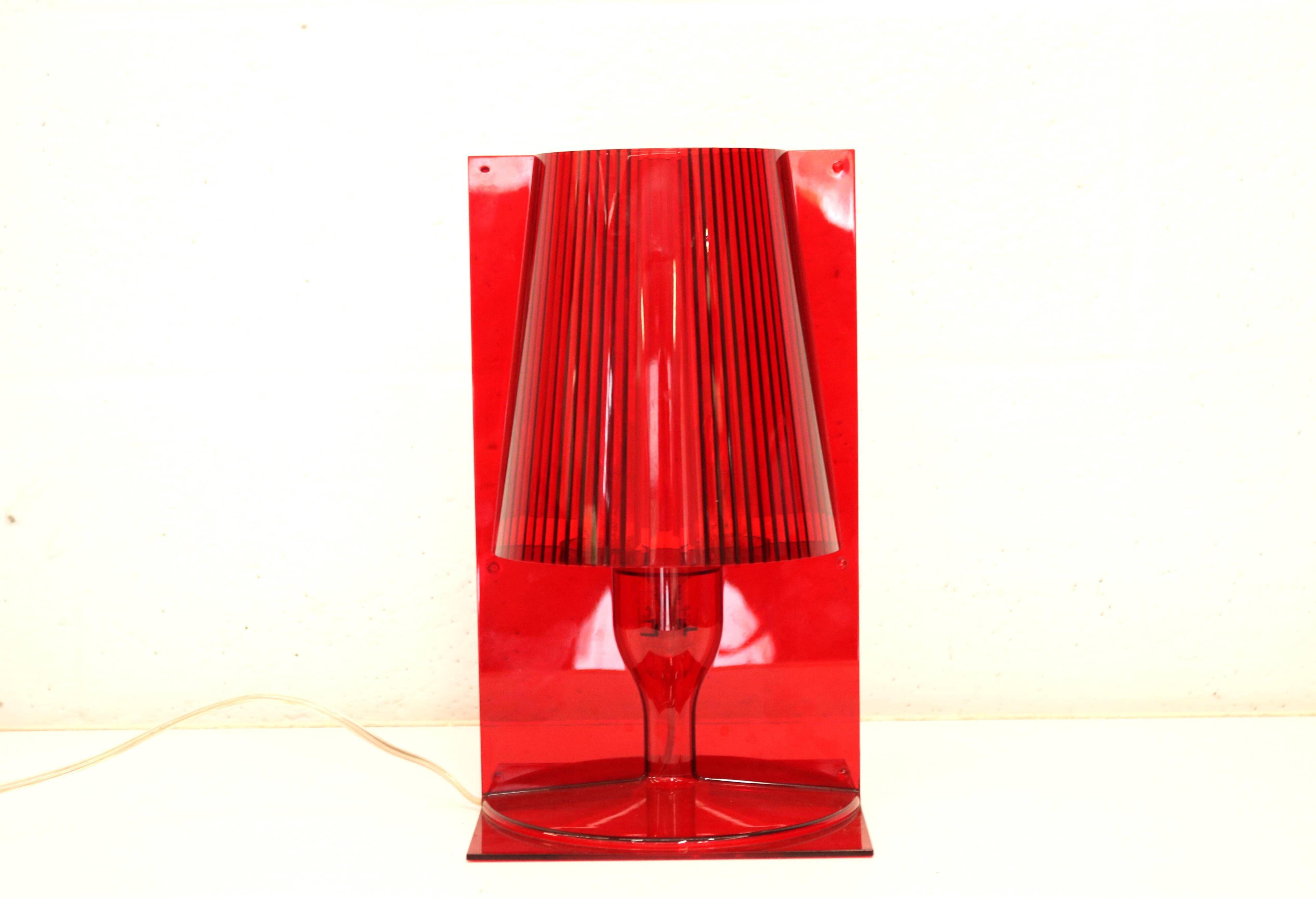 Red plastic Kartell table lamp - model Take - design by Ferruccio Laviani