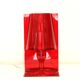 Red plastic Kartell table lamp - model Take - design by Ferruccio Laviani