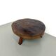 Brutalist coffee table in solid teak, monolithic slab, tripod base.