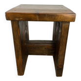 Brutalist stool made of solid wood in chalet style.