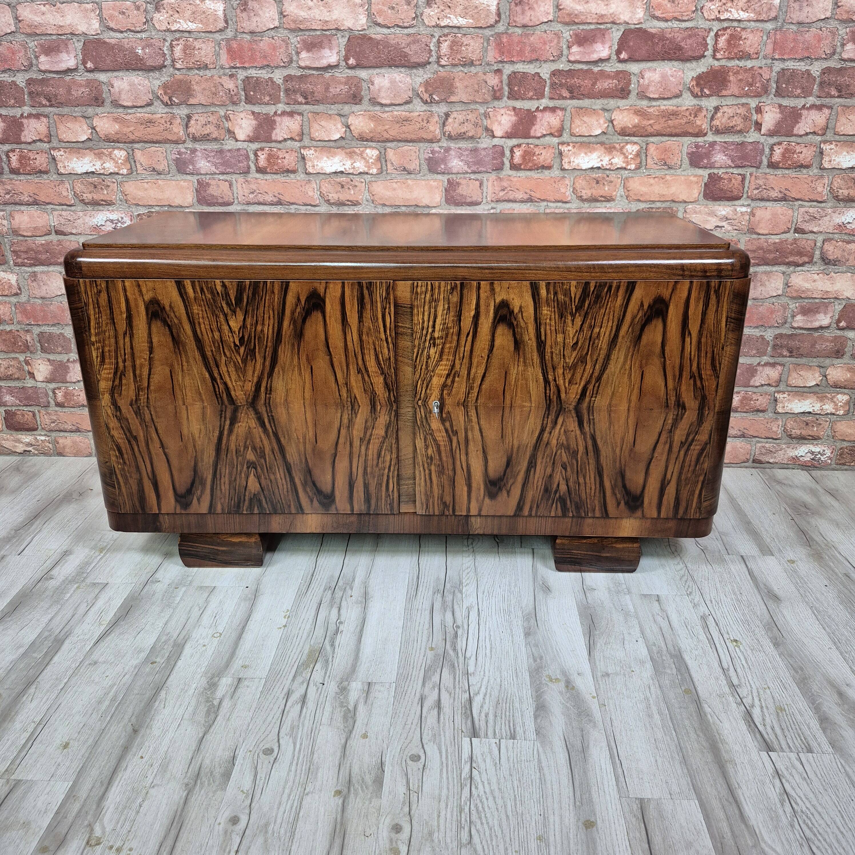 Low sideboard after renovation. Hypnotising veneer and Art Deco style.